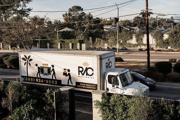 Royal Moving & Storage truck in front of luxury house